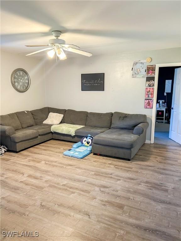 3062 Kings Lake Blvd Unit 7511, Naples, FL 34112 - living area featuring wood finished floors and a ceiling fan