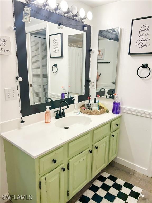 3062 Kings Lake Blvd Unit 7511, Naples, FL 34112 - bathroom with vanity and wood finished floors