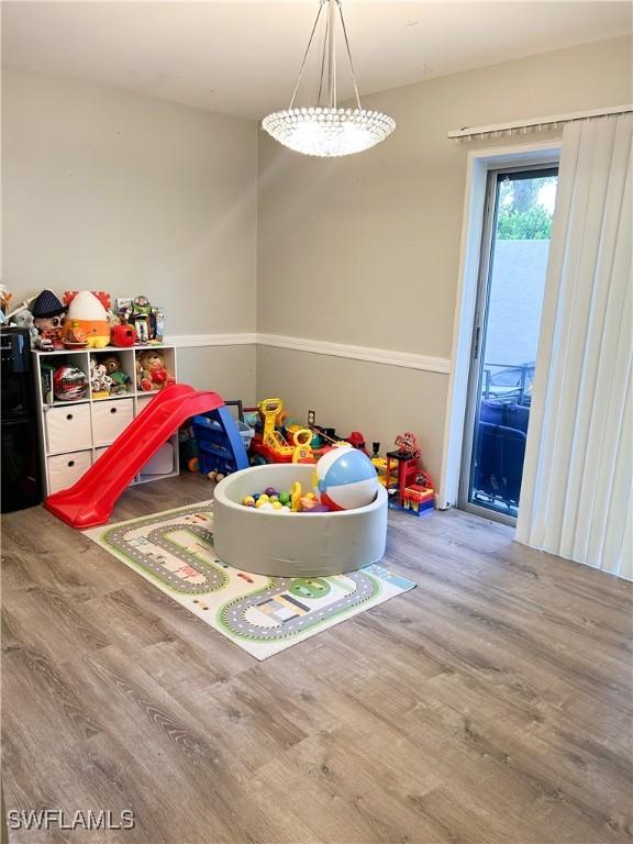 3062 Kings Lake Blvd Unit 7511, Naples, FL 34112 - rec room with wood finished floors
