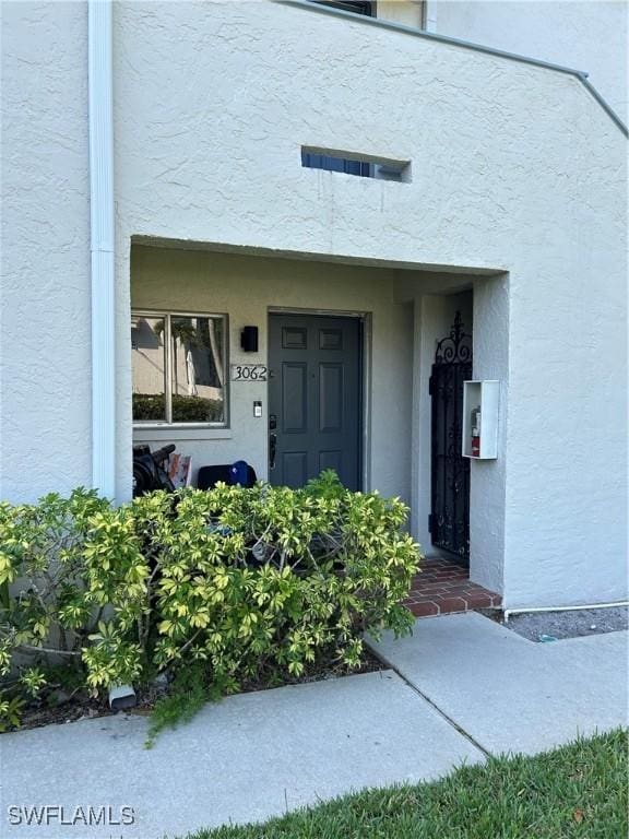 3062 Kings Lake Blvd Unit 7511, Naples, FL 34112 - entrance to property with stucco siding