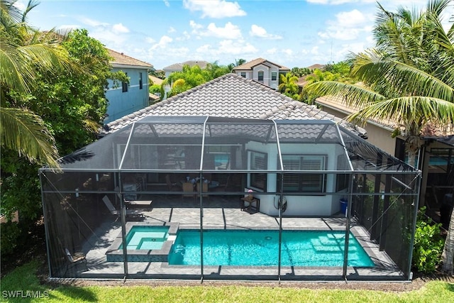 4330 Aurora St, Naples, FL 34119 - rear view of property featuring a tiled roof, a patio, a lanai, stucco siding, and a pool with connected hot tub
