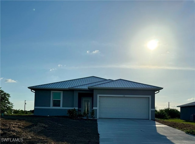 538 David Cir, Labelle, FL 33935 - view of front facade featuring stucco siding, driveway, a garage, and metal roof