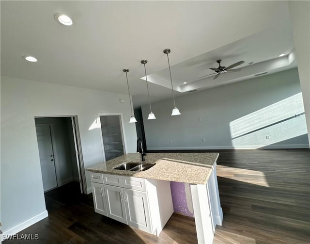 538 David Cir, Labelle, FL 33935 - kitchen featuring a sink, a center island with sink, dark wood-style flooring, white cabinets, and pendant lighting
