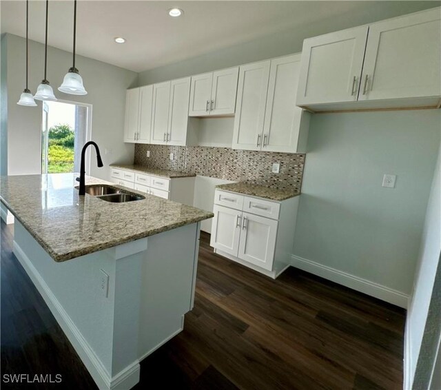 538 David Cir, Labelle, FL 33935 - kitchen with a sink, dark wood-type flooring, recessed lighting, light stone counters, and a kitchen island with sink