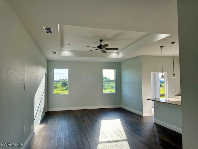 538 David Cir, Labelle, FL 33935 - spare room featuring a tray ceiling, dark wood-style flooring, and baseboards