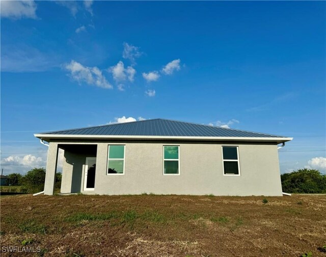 538 David Cir, Labelle, FL 33935 - view of side of home with stucco siding and metal roof