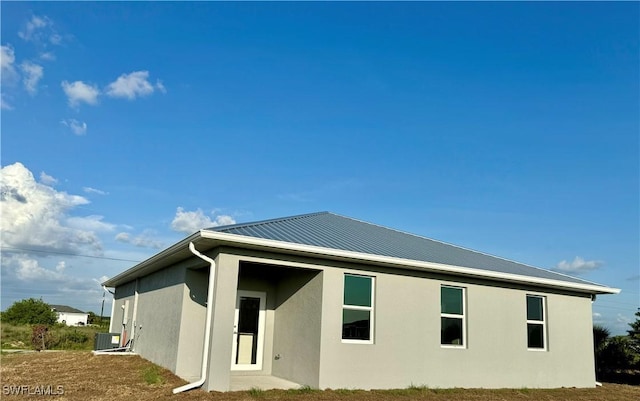 538 David Cir, Labelle, FL 33935 - rear view of property with stucco siding, central AC unit, and metal roof