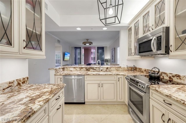 401 Bayfront Pl Unit 3301, Naples, FL 34102 - kitchen with stainless steel appliances, a sink, cream cabinetry, a peninsula, and recessed lighting