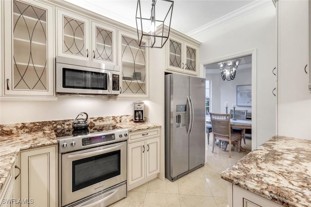 401 Bayfront Pl Unit 3301, Naples, FL 34102 - kitchen with stainless steel appliances, cream cabinets, a chandelier, crown molding, and glass insert cabinets