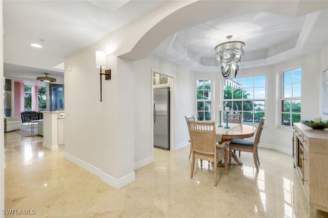 401 Bayfront Pl Unit 3301, Naples, FL 34102 - dining area featuring a chandelier, arched walkways, healthy amount of natural light, and baseboards