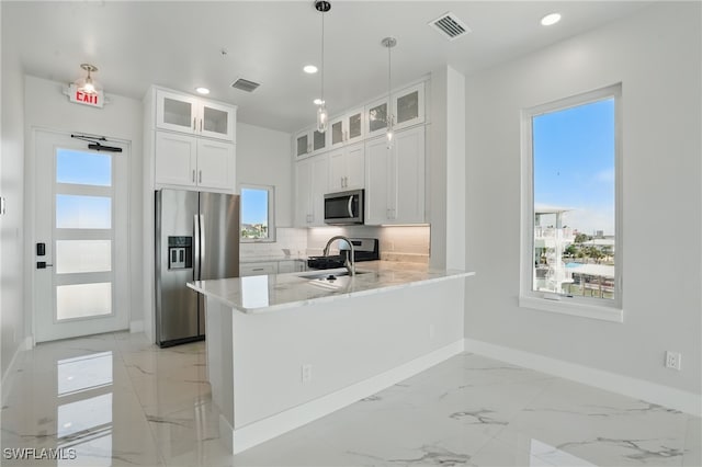 855 Lagoon St Unit 3, Fort Myers Beach, FL 33931 - kitchen with appliances with stainless steel finishes, baseboards, light marble finish floors, backsplash, and recessed lighting