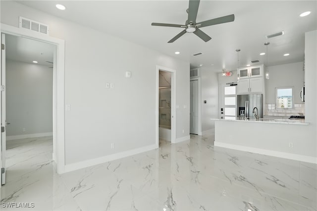855 Lagoon St Unit 3, Fort Myers Beach, FL 33931 - unfurnished living room featuring light marble finish floors, baseboards, ceiling fan, recessed lighting, and a sink