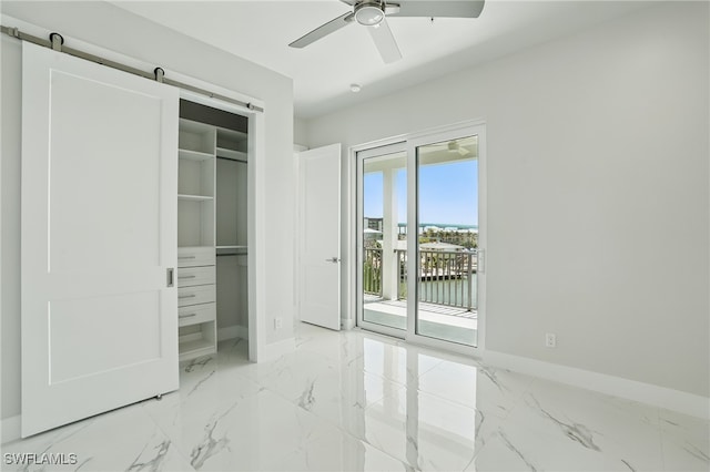 855 Lagoon St Unit 3, Fort Myers Beach, FL 33931 - unfurnished bedroom with baseboards, access to outside, marble finish flooring, and a closet