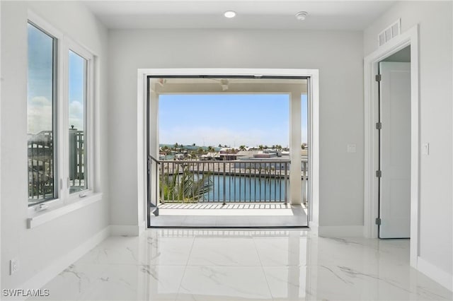 855 Lagoon St Unit 3, Fort Myers Beach, FL 33931 - spare room featuring marble finish floors, baseboards, and a water view