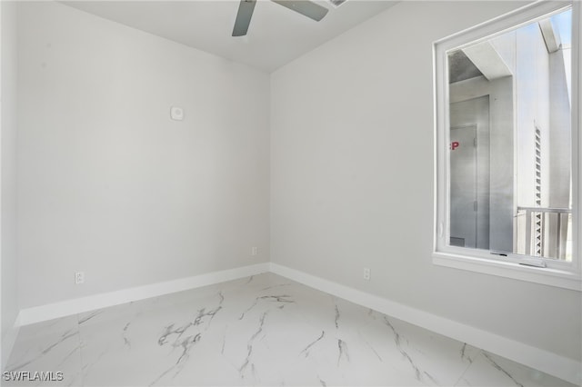 855 Lagoon St Unit 3, Fort Myers Beach, FL 33931 - unfurnished room featuring baseboards, marble finish flooring, and a ceiling fan