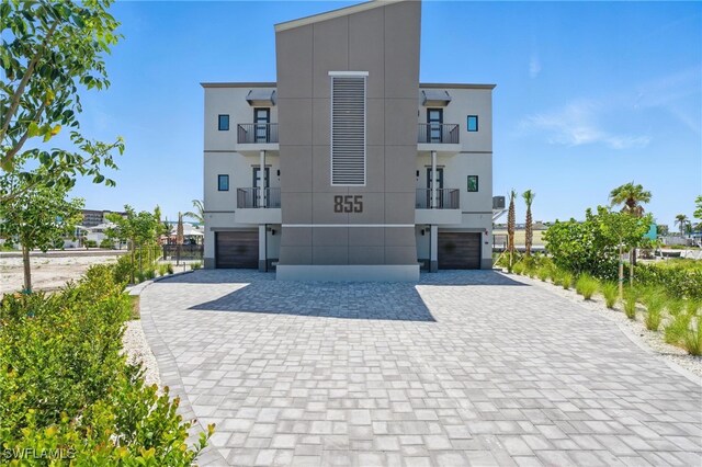 855 Lagoon St Unit 3, Fort Myers Beach, FL 33931 - view of building exterior with a garage and decorative driveway
