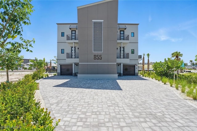 855 Lagoon St Unit 4, Fort Myers Beach, FL 33931 - view of building exterior with a garage and decorative driveway