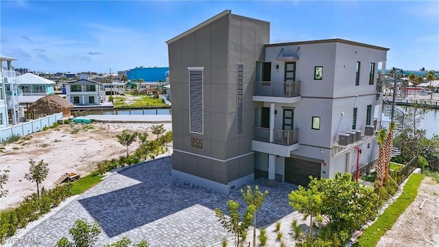 855 Lagoon St Unit 4, Fort Myers Beach, FL 33931 - view of building exterior featuring a garage and a water view