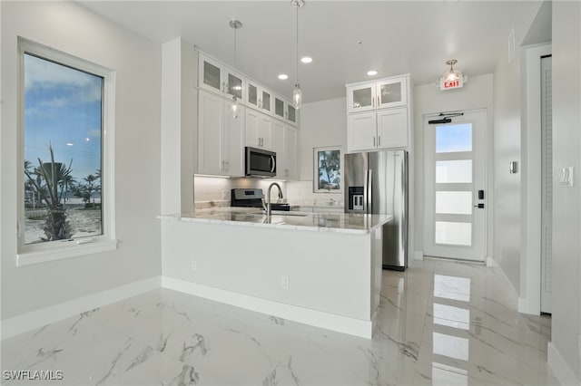 855 Lagoon St Unit 4, Fort Myers Beach, FL 33931 - kitchen with appliances with stainless steel finishes, baseboards, recessed lighting, a peninsula, and light marble finish flooring