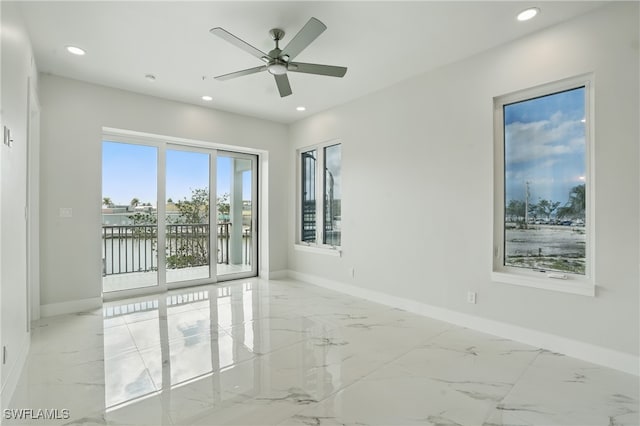 855 Lagoon St Unit 4, Fort Myers Beach, FL 33931 - empty room with baseboards, light marble finish floors, recessed lighting, ceiling fan, and a water view