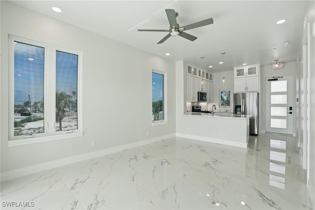 855 Lagoon St Unit 4, Fort Myers Beach, FL 33931 - unfurnished living room featuring baseboards, light marble finish flooring, a ceiling fan, and recessed lighting