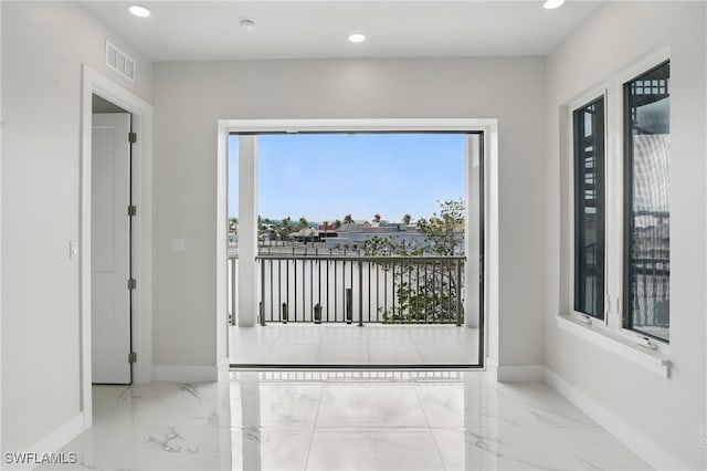 855 Lagoon St Unit 4, Fort Myers Beach, FL 33931 - spare room featuring baseboards, marble tiled flooring, and recessed lighting