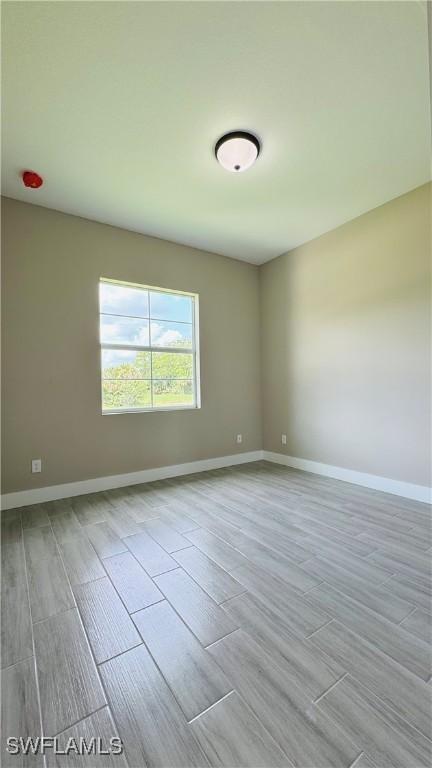 1115 Leader St, Labelle, FL 33935 - spare room with wood finished floors and baseboards