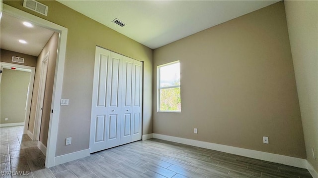 1115 Leader St, Labelle, FL 33935 - unfurnished bedroom with wood tiled floors, baseboards, and a closet
