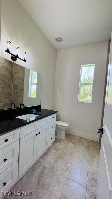 1115 Leader St, Labelle, FL 33935 - bathroom featuring vanity, healthy amount of natural light, toilet, and tile patterned flooring