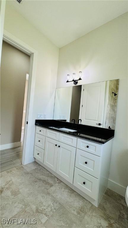 1115 Leader St, Labelle, FL 33935 - bathroom with vanity, baseboards, and toilet
