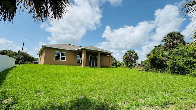 1115 Leader St, Labelle, FL 33935 - back of property featuring stucco siding and a yard