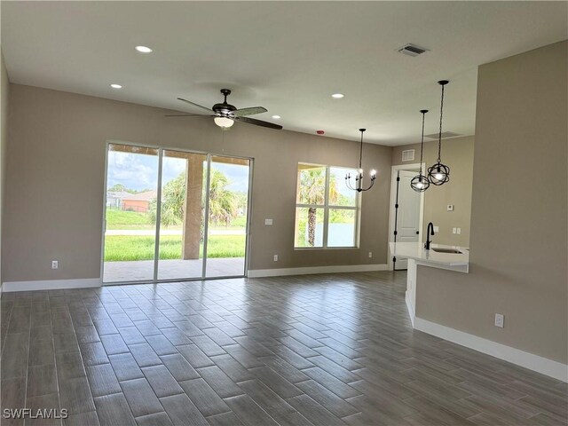 1115 Leader St, Labelle, FL 33935 - unfurnished living room featuring baseboards, a sink, recessed lighting, and dark wood-style flooring
