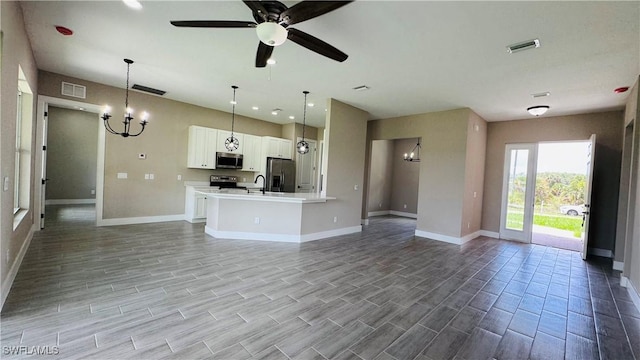 1115 Leader St, Labelle, FL 33935 - unfurnished living room with a chandelier, baseboards, and recessed lighting