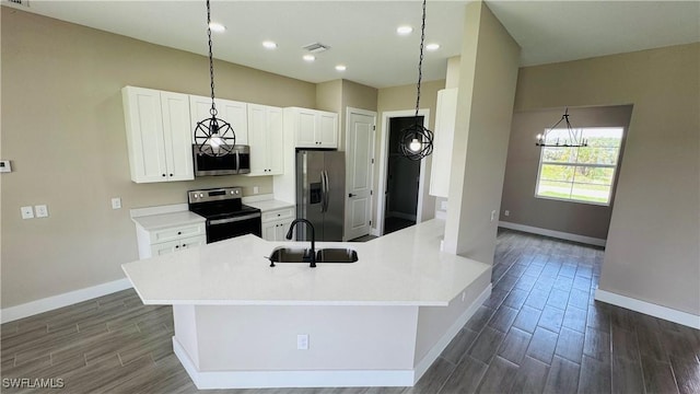 1115 Leader St, Labelle, FL 33935 - kitchen with stainless steel appliances, a sink, baseboards, a chandelier, and dark wood finished floors