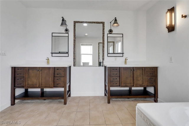 2940 14th Ave SE, Naples, FL 34117 - full bathroom with two vanities, a bath, and tile patterned flooring