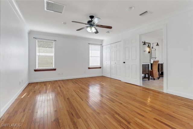 2940 14th Ave SE, Naples, FL 34117 - unfurnished bedroom featuring multiple windows, light wood finished floors, ornamental molding, and ceiling fan