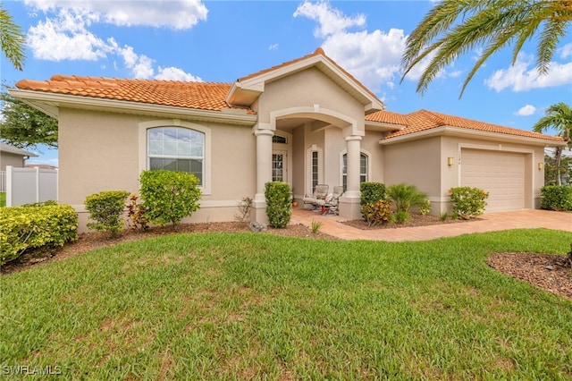 1206 SW 18th Ave, Cape Coral, FL 33991 - mediterranean / spanish-style home featuring a tiled roof, stucco siding, a garage, and concrete driveway