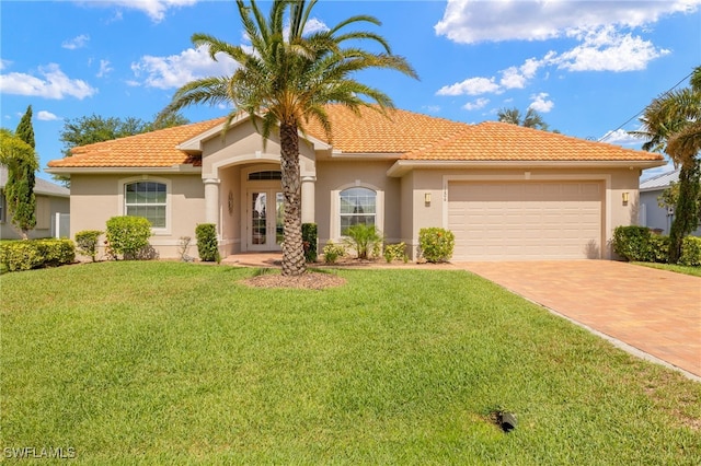 1206 SW 18th Ave, Cape Coral, FL 33991 - mediterranean / spanish-style home with french doors, decorative driveway, a tiled roof, and an attached garage