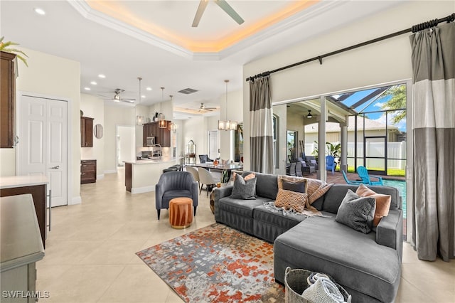 1206 SW 18th Ave, Cape Coral, FL 33991 - living room featuring ceiling fan, a raised ceiling, light tile patterned floors, crown molding, and recessed lighting