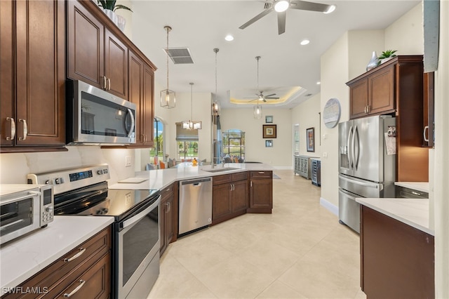 1206 SW 18th Ave, Cape Coral, FL 33991 - kitchen with appliances with stainless steel finishes, a ceiling fan, a peninsula, light countertops, and recessed lighting