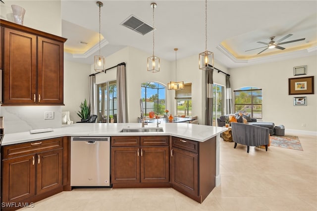 1206 SW 18th Ave, Cape Coral, FL 33991 - kitchen featuring a tray ceiling, stainless steel dishwasher, open floor plan, and light countertops