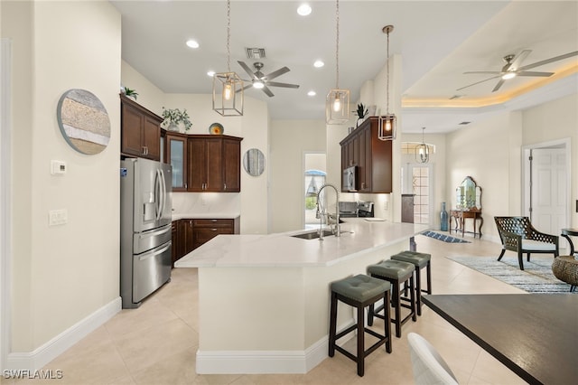 1206 SW 18th Ave, Cape Coral, FL 33991 - kitchen featuring stainless steel appliances, ceiling fan, a sink, a peninsula, and a kitchen bar