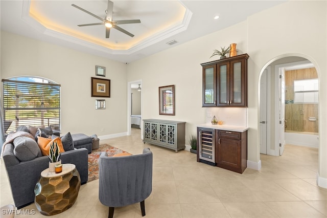 1206 SW 18th Ave, Cape Coral, FL 33991 - living room with wine cooler, a ceiling fan, arched walkways, and baseboards