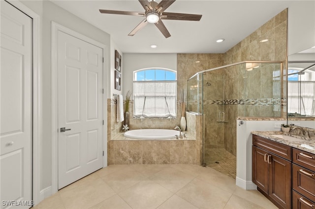 1206 SW 18th Ave, Cape Coral, FL 33991 - bathroom featuring a garden tub, a stall shower, vanity, ceiling fan, and tile patterned floors
