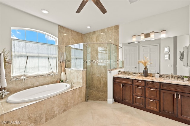 1206 SW 18th Ave, Cape Coral, FL 33991 - bathroom featuring a garden tub, a ceiling fan, double vanity, a stall shower, and tile patterned flooring