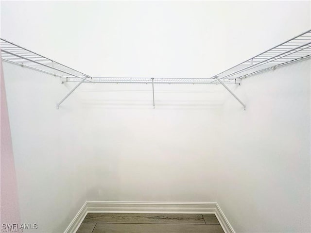 8088 Sanctuary Dr Unit 1, Naples, FL 34104 - spacious closet with dark wood-style flooring