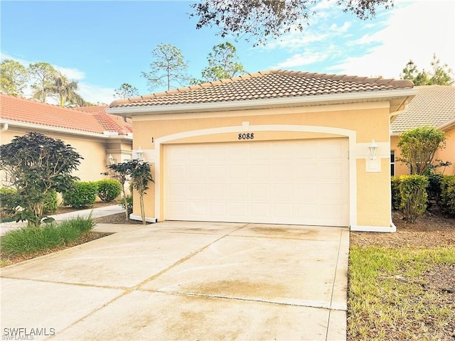 8088 Sanctuary Dr Unit 1, Naples, FL 34104 - mediterranean / spanish house featuring stucco siding, a tiled roof, and driveway