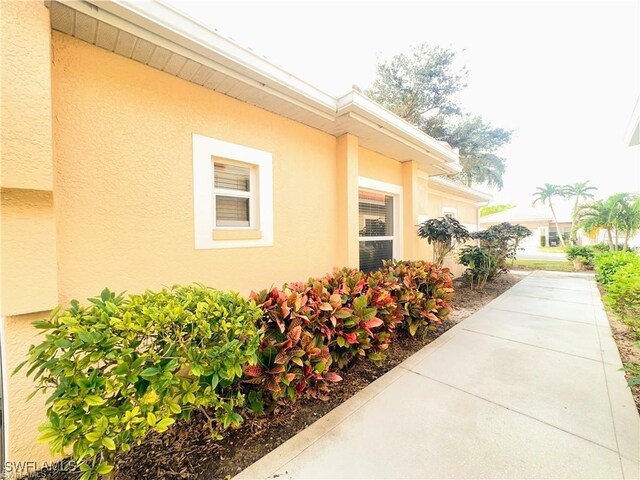 8088 Sanctuary Dr Unit 1, Naples, FL 34104 - view of home's exterior with stucco siding