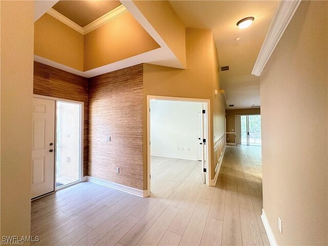 8088 Sanctuary Dr Unit 1, Naples, FL 34104 - foyer featuring crown molding, light wood finished floors, baseboards, and a high ceiling