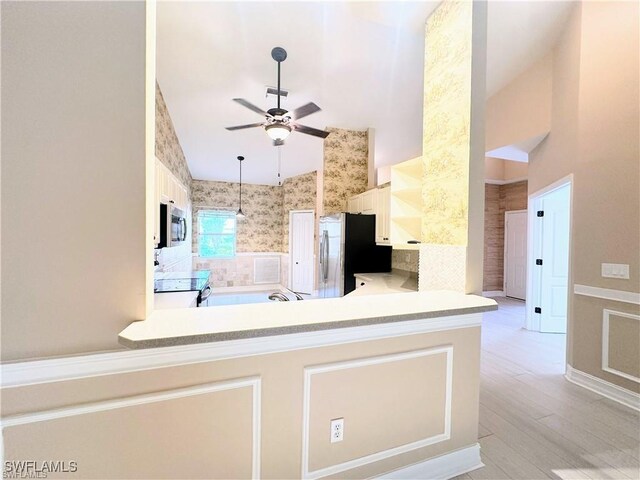 8088 Sanctuary Dr Unit 1, Naples, FL 34104 - kitchen featuring stainless steel appliances, ceiling fan, wallpapered walls, wainscoting, and light countertops